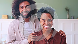 Multiracial happy young couple of African American woman and Arabian man at home