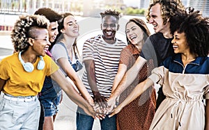 Multiracial happy young people putting their hands on top of each other - Diverse friends unity togetherness in volunteer