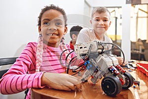 Multiracial kids using building kit. photo