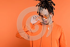 multiracial man with dreadlocks wearing stylish