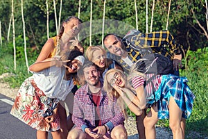 Multiracial millennial friends taking selfie with funny faces while exploring world