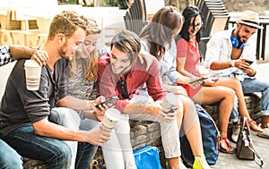 Multiracial millennials group using smart phone at city college photo