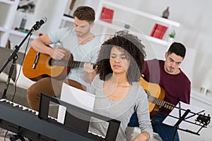 Multiracial music band performing in recording studio