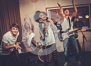 Multiracial music band in a studio