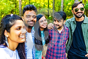 Multiracial pakistanian happy friends at picnic camping park