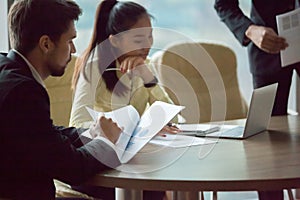 Multiracial partners brainstorming at negotiations meeting in of photo