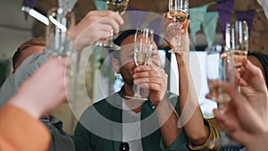 Multiracial people celebrating party in festive decorated room together close up