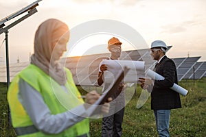 Multiracial people discussing project of solar station