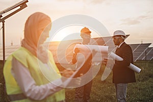 Multiracial people discussing project of solar station