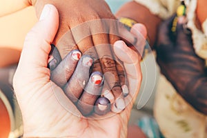 Multiracial people holding hands