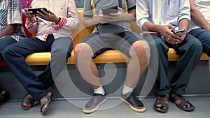 Multiracial people using mobile devices in subway