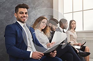 Multiracial people waiting in queue preparing for job interview