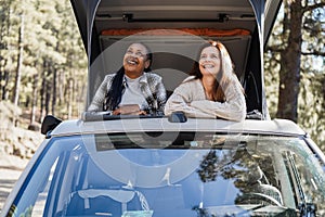 Multiracial senior women friends having fun inside camper van - Focus on african woman face