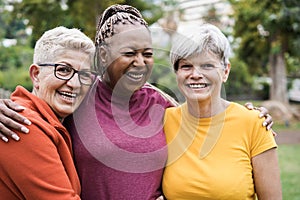 Multiracial senior women having fun together after sport workout outdoor - Focus on left female face