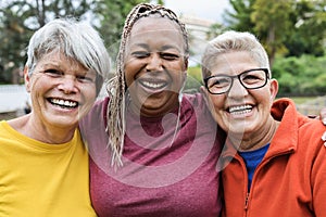 Multiracial senior women having fun together after sport workout outdoor - Main focus on right female face
