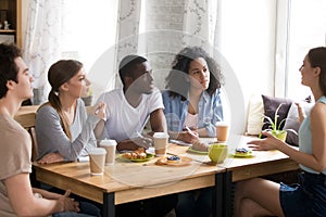 Multiracial students studying together in cafe, brainstorm, share ideas