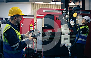 Multiracial tachnicial engineer training with robot arm