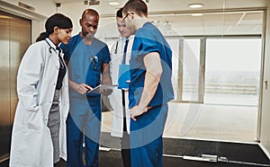 Multiracial team of doctors discussing a patient