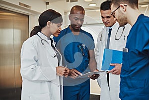 Multiracial team of doctors discussing a patient