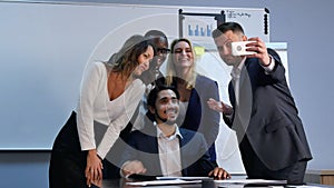 Multiracial team taking selfie at business meeting