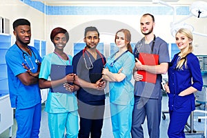 Multiracial team of young doctors in a hospital standing in a operating room