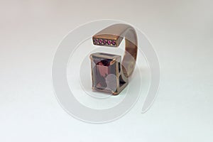 Multisize ring with big faceted rectangular gemstone smoky quartz and several small faceted transparent red almandine