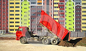 Multistorey building apartment house and dump truck unload soil