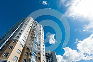 Multistorey residential house on blue sky background