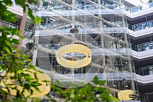 Multistory glass building with chandeliers and staircase