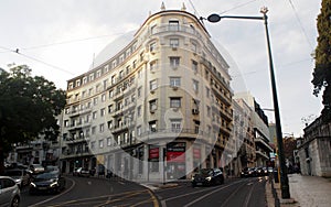 Multistory mid-20th-century residential building with round corner section, in Rato district, Lisbon, Portugal photo