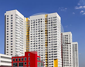 Multistory new modern apartment building against the blue sky. Stylish living block of flats. Newly built block of flats