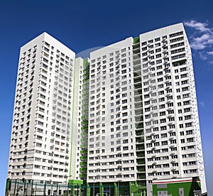 Multistory new modern apartment building against the blue sky. Stylish living block of flats. Newly built block of flats