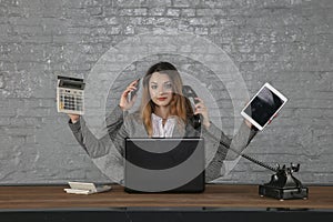 Multitasking business woman sitting at desk photo