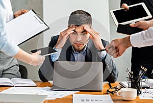 Overworked Businessman Sitting At Laptop Overloaded With Work In Office photo