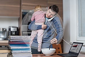 Multitasking father is babysitting and working at home