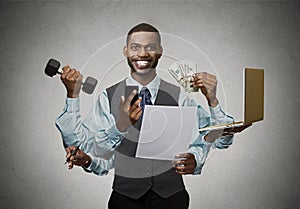 Multitasking happy business man on grey wall background