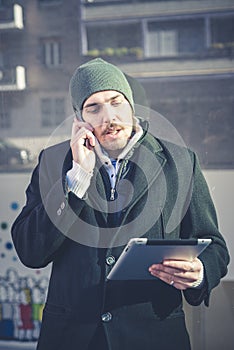 Multitasking man using tablet, laptop and cellhpone