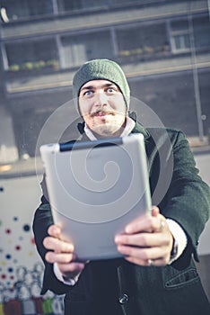 Multitasking man using tablet, laptop and cellhpone