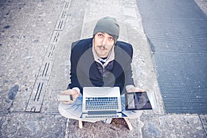 Multitasking man using tablet, laptop and cellhpone