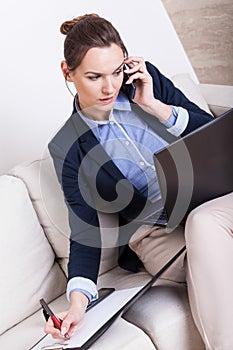 Multitasking woman working at home