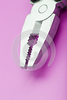 Multitool is a multi-functional tool on a pink background. The concept of an open, flying multi-tool with free space