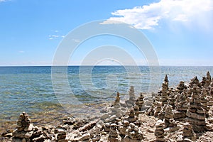 A multitude of cairns lining the rocky shoreline of Lake Michigan in Cave Point County Park