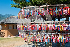 The multitude of colorful hearts with tassels for wishes and names of visitors on the stand of Yun Lai viewpoint