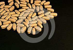 Multivitamin tablets sprinkled and a pills bottle . Selective focus