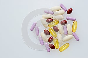 Multivitamins and supplements on white background, Including Vitamin c, vitamin E, fish oil capsules, top view