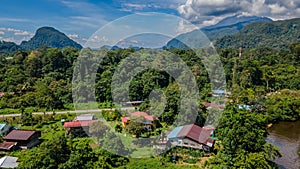 Mulu village landscape with houses surrounded by tropical forest and mountains near Gunung Mulu national park. Borneo. Sarawak.