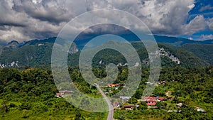 Mulu village with road, tropical forest and mountains near Gunung Mulu national park. Borneo. Sarawak.