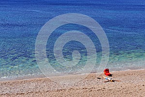 Mum with a baby in stroller lyuing on the beach