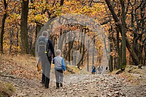 Mum and child are walking along the mountain hiking trail. Family spending time