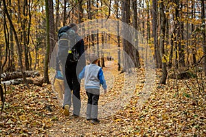 Mum and child are walking along the mountain hiking trail. Family spending time